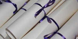 diplomas with purple ribbons