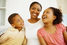 Two children smiling at mother