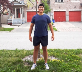noel standing in front of a tree