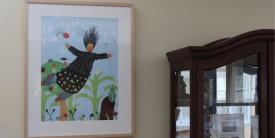 A framed paining hun on a wall