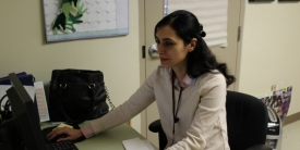 A crisis line worker sitting at a desk