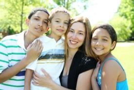 Mother and three children smiling
